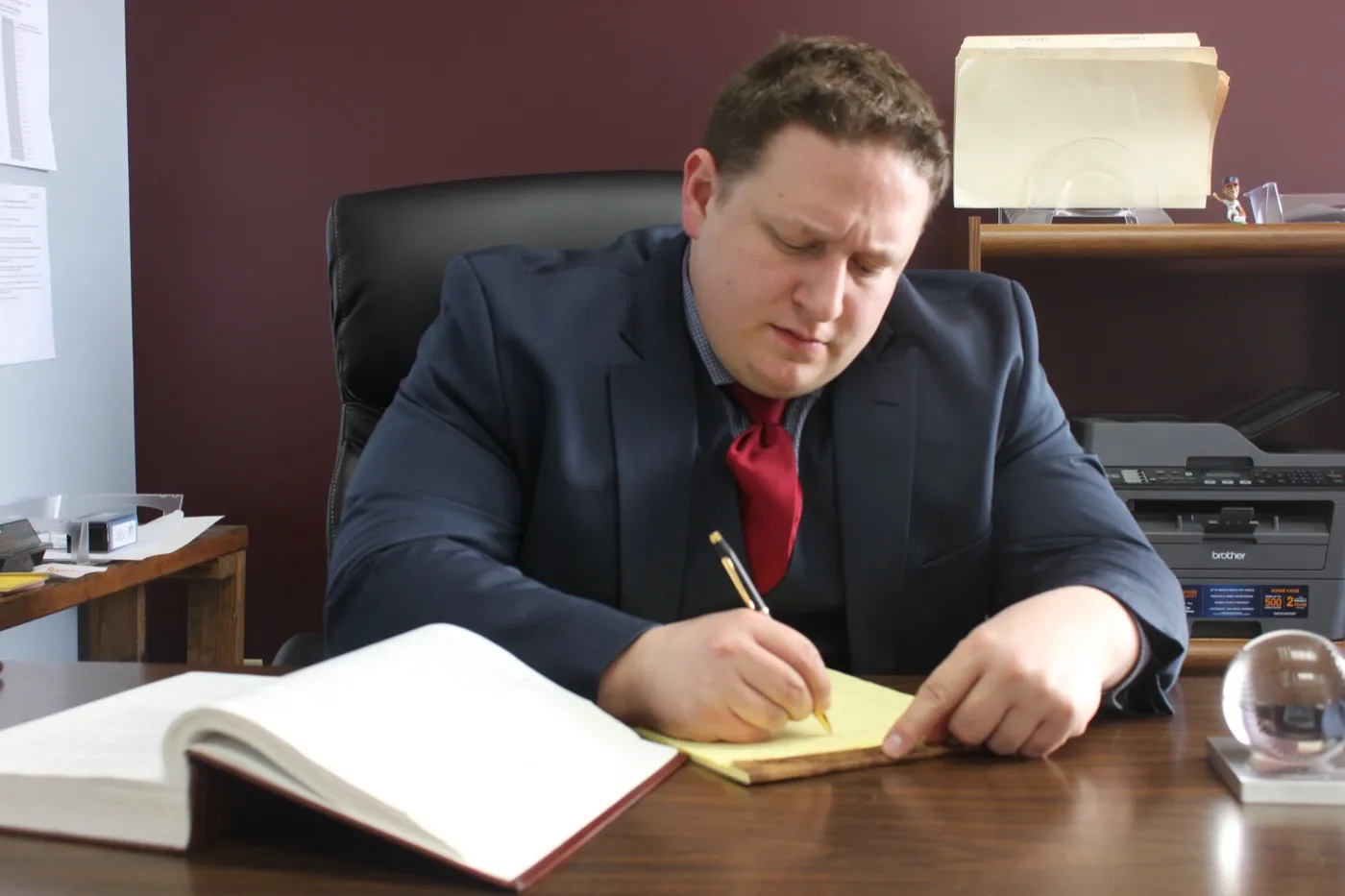 Attorney Mark Cicero writing at his desk